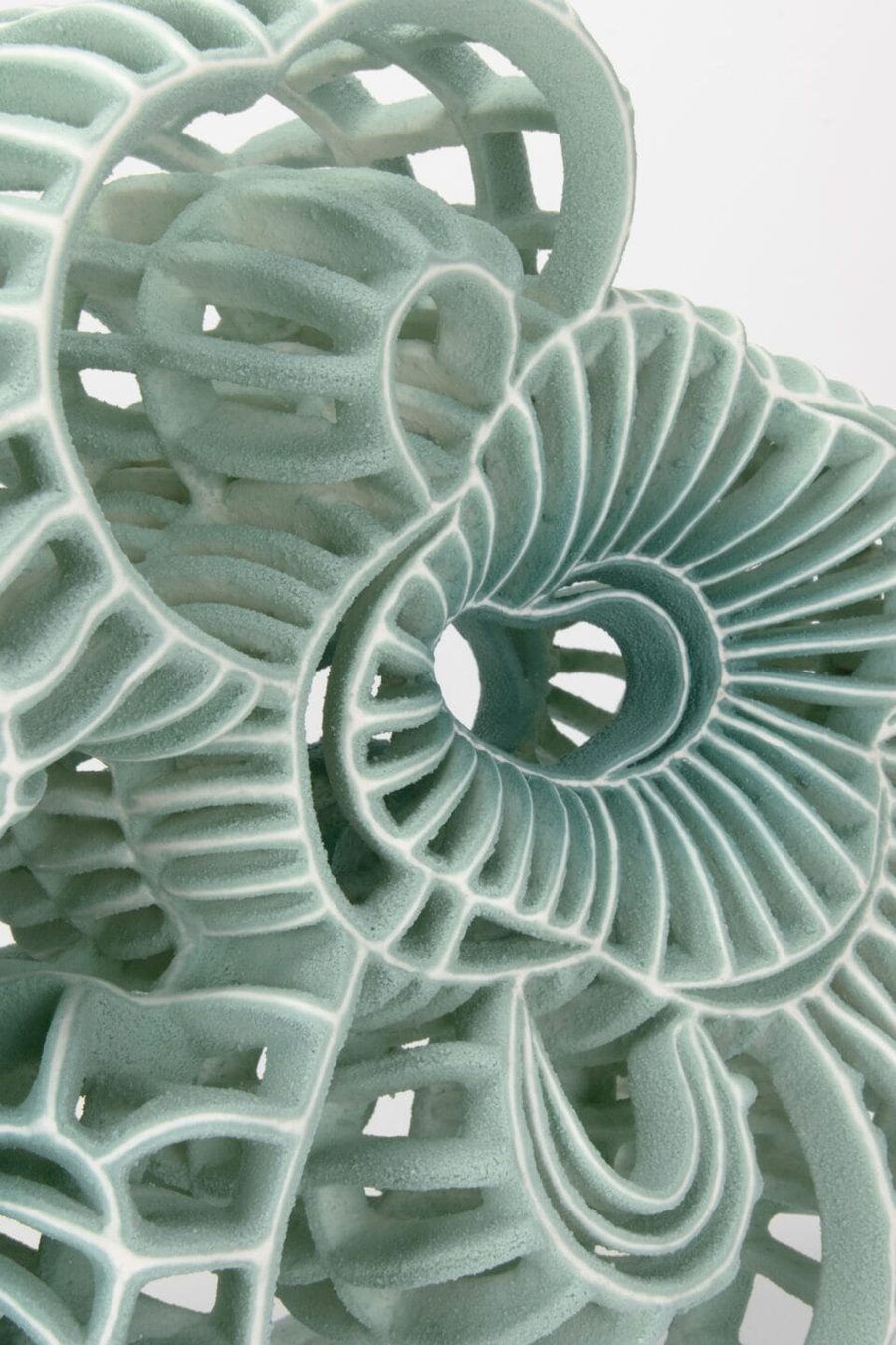 a detail of an abstract ceramic sculpture with seafoam green, 2025